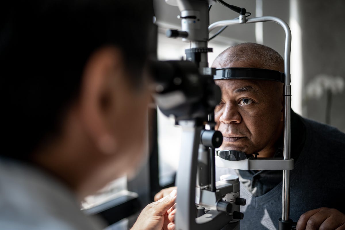 A man sits down for an eye exam