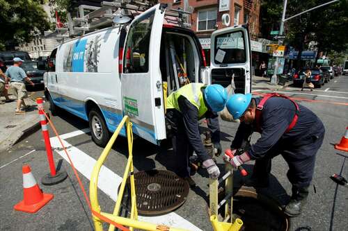 Con Edison field operators in New York City check on feeder cables at the corner of First Ave. and E. 15th St. as they try to prevent a blackout due to increased consumption during the heat wave.