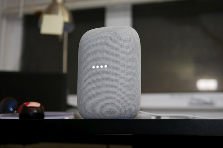 Nest Audio speaker in a moody dark room.