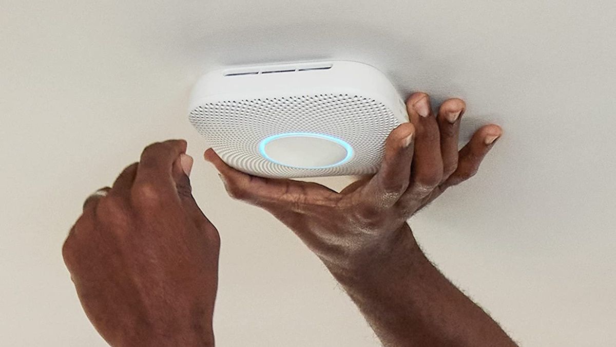 Person setting up google nest protect