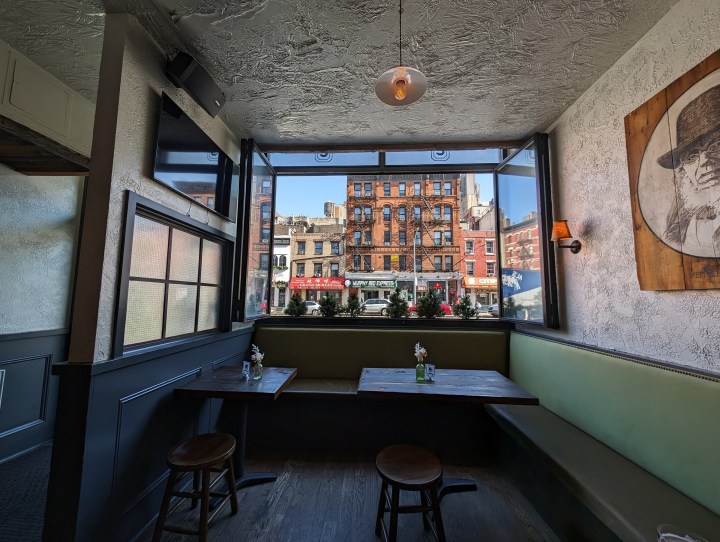 Photo of a restaurant in New York City, with a window looking at a building across the street, taken with the Google Pixel 8 Pro.