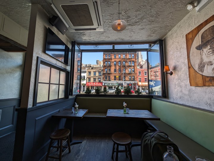 Photo of a restaurant in New York City, with a window looking at a building across the street, taken with the Google Pixel 8 Pro.