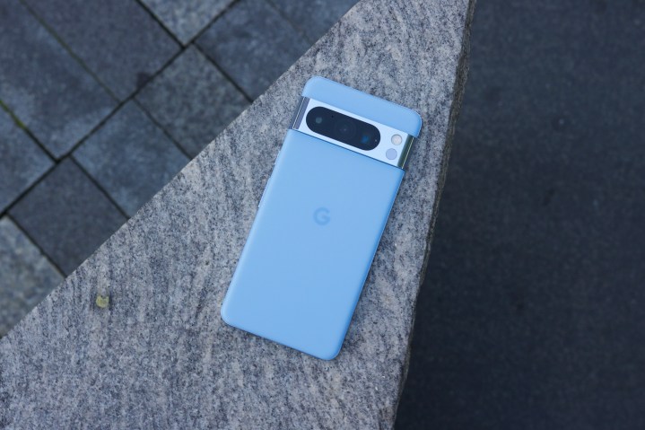 The Google Pixel 8 Pro laying face-down on a concrete structure.