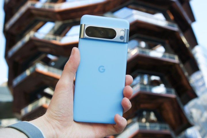 Someone holding the Bay blue Google Pixel 8 Pro.