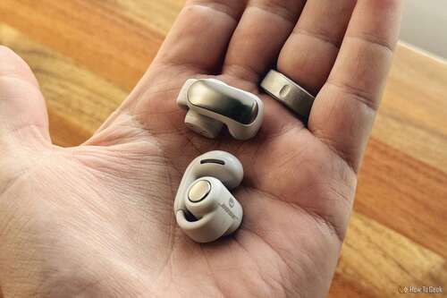 hand holding Bose Ultra Open Earbuds