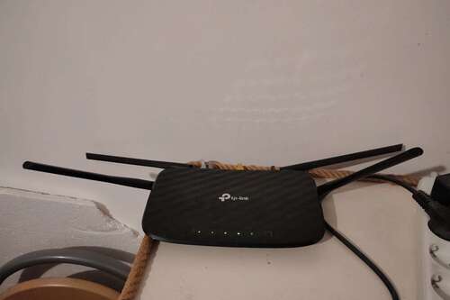 The TP Link Archer C6 Wi-Fi Router with the antennas angled.