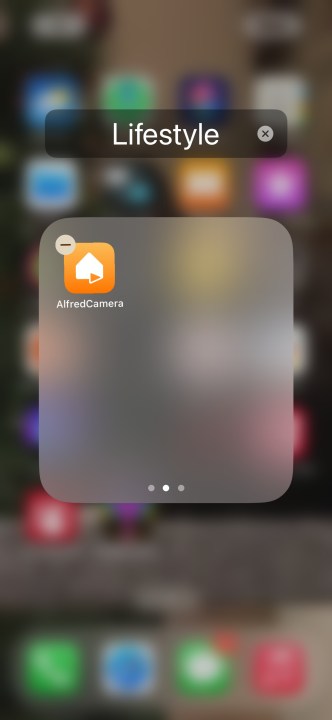 Hiding an app in the last page of a folder.