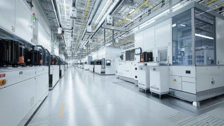 Wide shot of Bright Advanced Semiconductor Production Fab Cleanroom with Working Overhead Wafer Transfer System