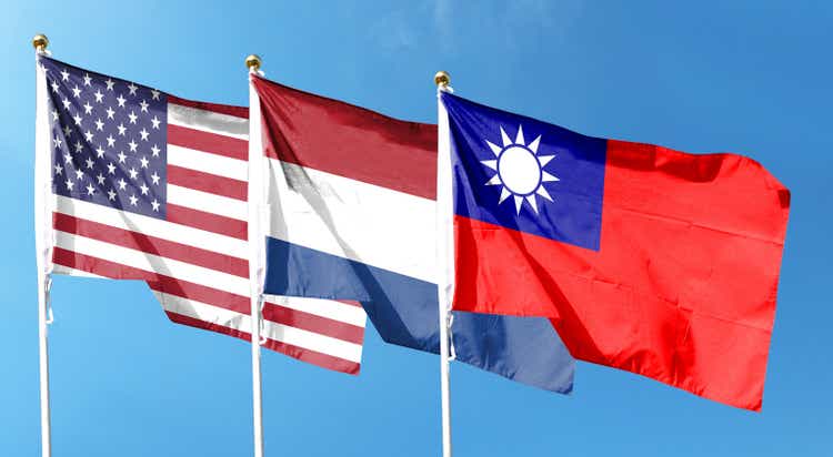 American flag with Taiwan flag and Netherlands flag on cloudy sky. waving in the sky