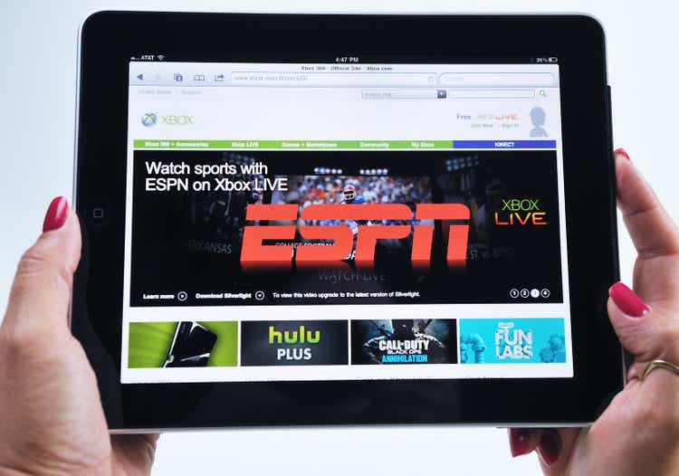 Woman Holding an iPad Displaying ESPN Xbox Video Game