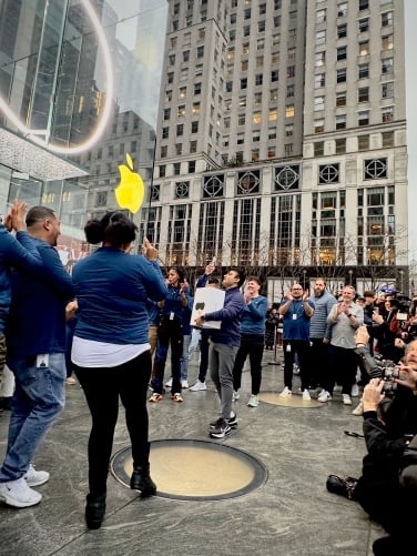 The first person in line exit the Apple store, Apple Vision Pro in hand.