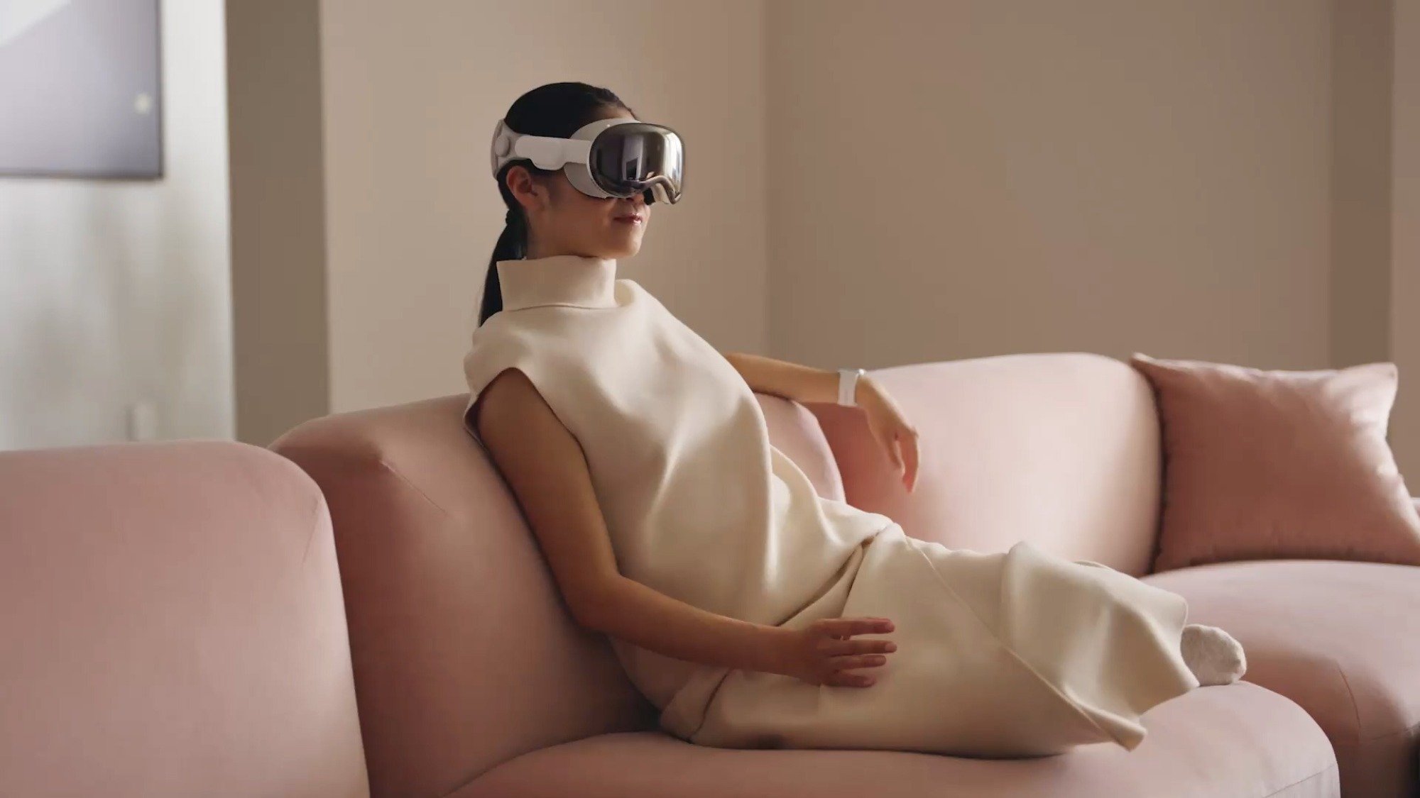 Woman wearing Apple Vision Pro in living room