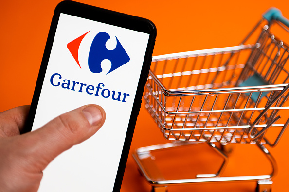 In this photo illustration a Carrefour logo seen displayed...