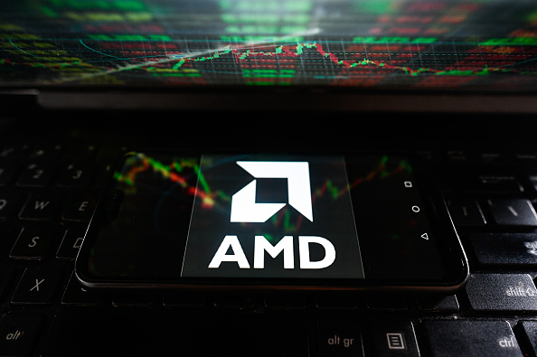 In this photo illustration an AMD logo seen displayed on a...