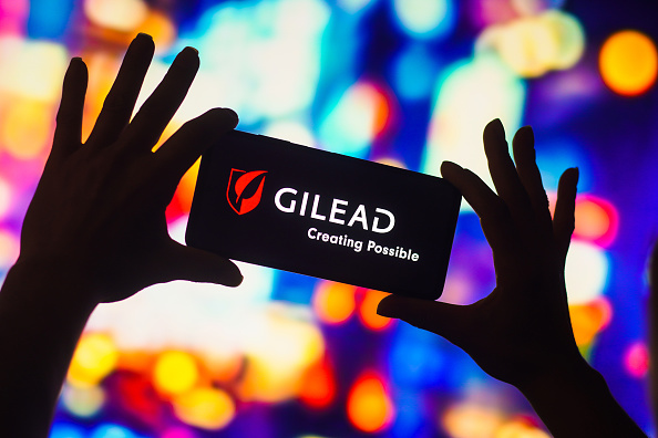 In this photo illustration, the Gilead Sciences logo is...