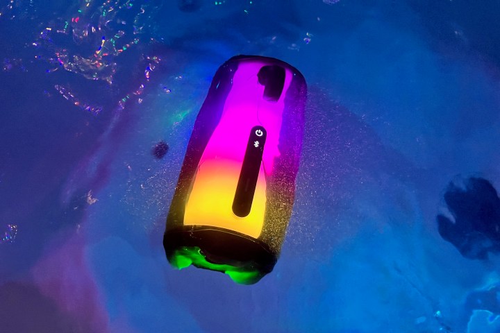 The JBL Pulse 5 Bluetooth speaker submerged in a hot tub.