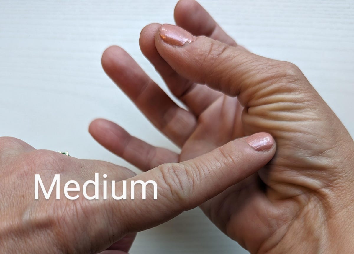 medium: finger poking hand with thumb and middle finger touching