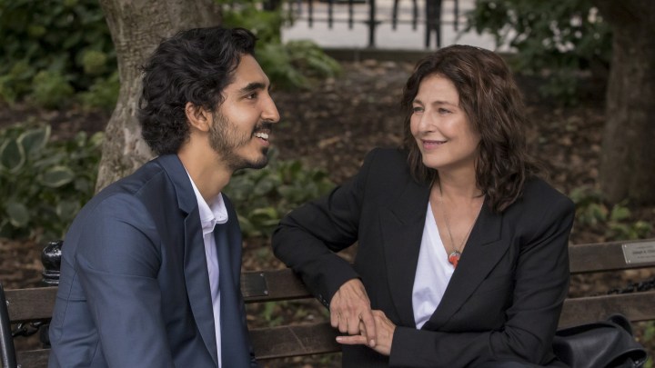 A man and a woman sit on a bench with each other.