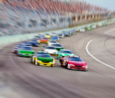 Race cars racing around a track.