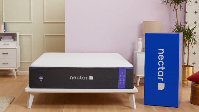 Nectar Premier Mattress on top of a bed frame and next to the box it came in.