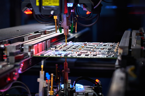 Robotic Arm Installing Component at Circuit Board