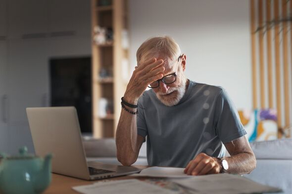 Senior man reading touching letter from friend, notification about increased healthcare costs, bad medical test results, hight utility bill. Elderly m