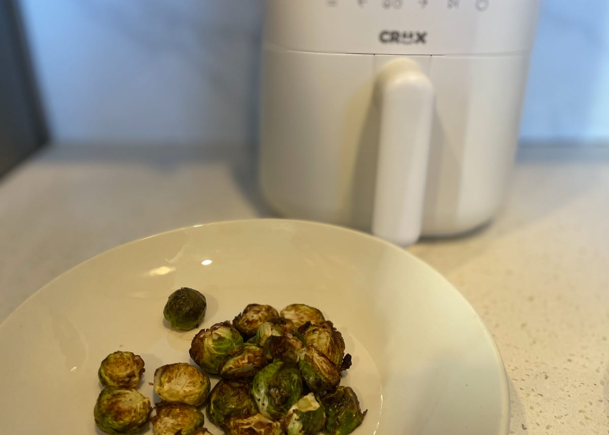 brussels sprouts in bowl in front of air fryer