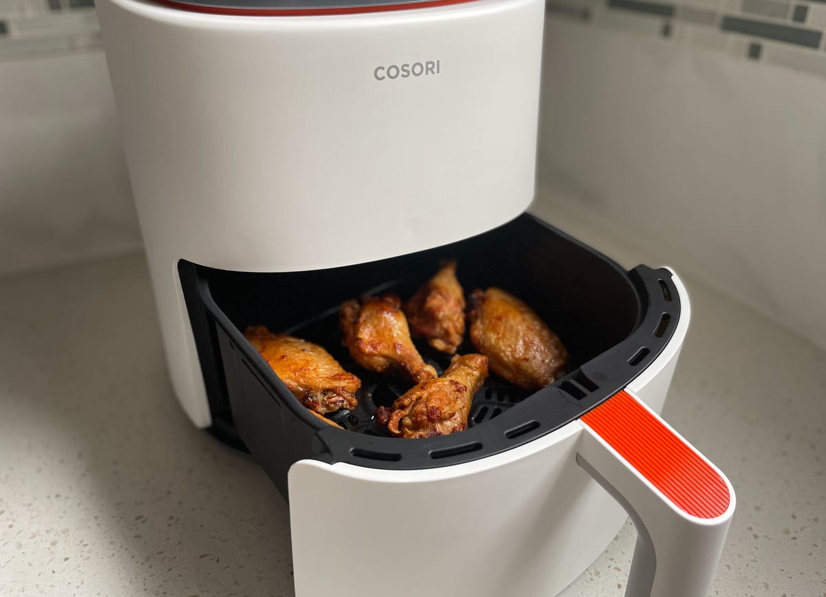 wings in air fryer basket on counter