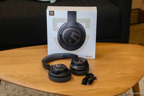 SoundPEATS Space headphones with 3.5mm cord and charging cable in front of box