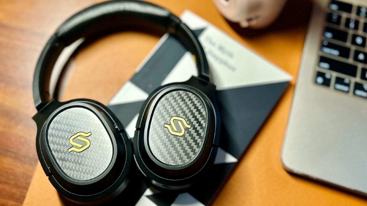 The Edifier Stax Spirit S3 headphones lying on a wooden desk