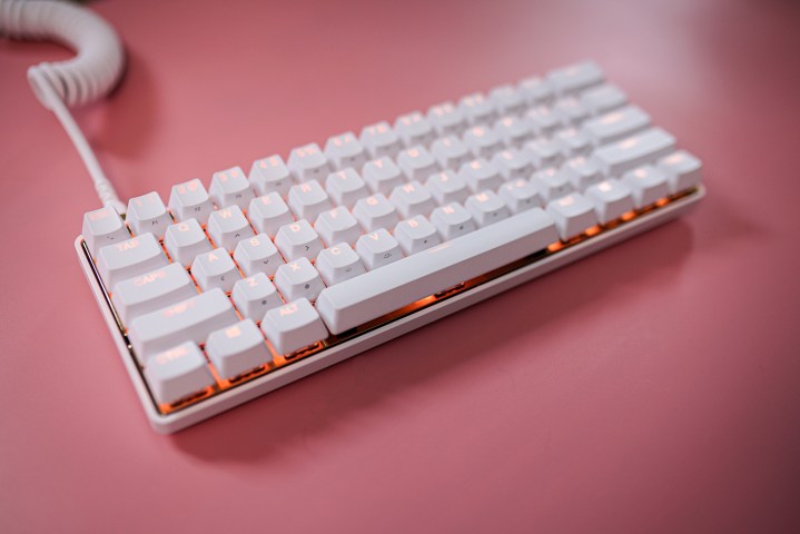 The Steelseries White Gold keyboard on a pink background.