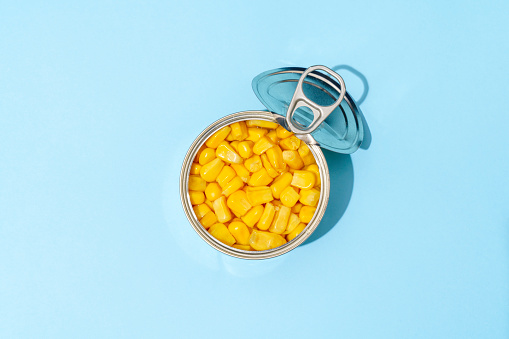 Sweetcorn Grains In A Can On Blue Background