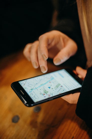 Person holding a black smartphone.