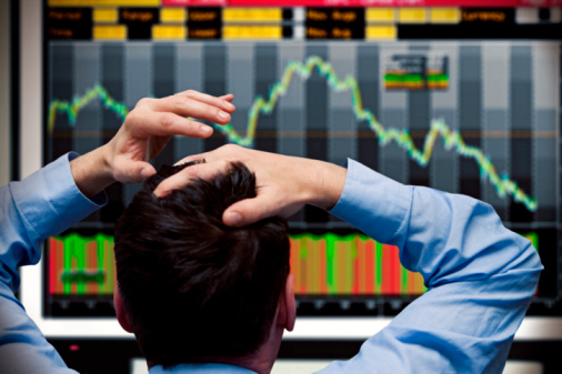 Trader watching stocks crash on screen