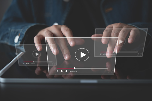 Video marketing concept. Woman playing video content online streaming, running short clip on digital tablet. Marketing technology and advertising for online business, internet network
