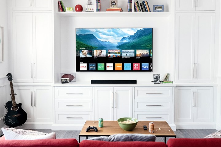 A wall-mounted Vizio TV in a white room.