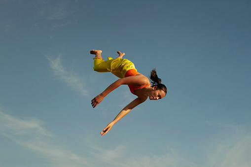 Woman falling upside down from sky