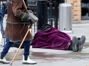 A homeless person sleeps in the ByWard Market