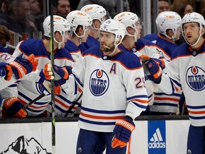 Leon Draisaitl skates past the Oilers bench celebrating his goal