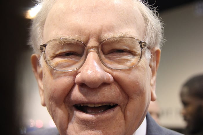 A close up of Warren Buffett smiling.