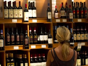 A customer browses wine for sale at a Liquor Control Board of Ontario (LCBO) store. Even now, at the approach of International Women's Day — which supposedly celebrates our equal status with men — the marketing message on some bottles is that we've haven't come a long way, baby.