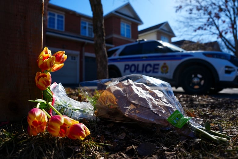 Flowers sit at the scene of a homicide where six people were found dead in the Barrhaven suburb of Ottawa on Thursday, March 7, 2024. 