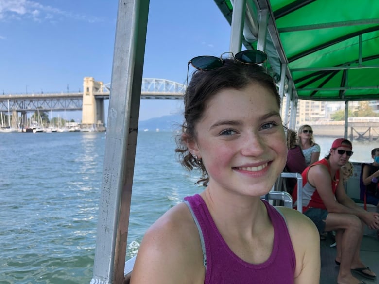 A smiling young woman on a boat