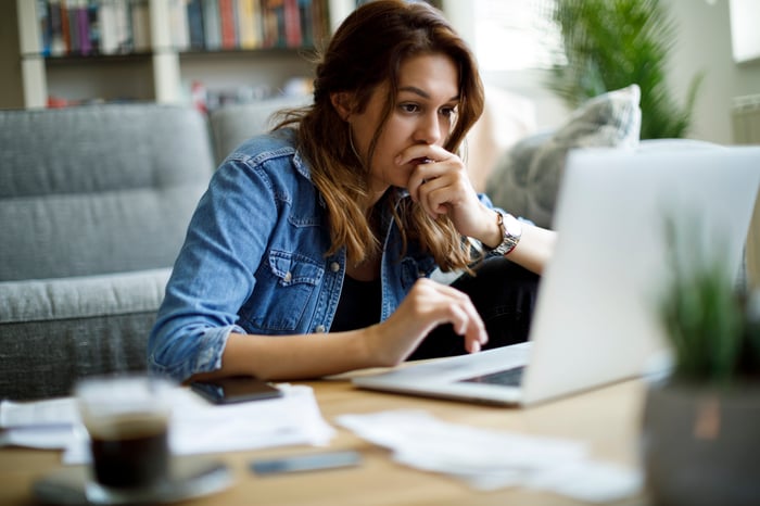 Individual investor looking at a device.