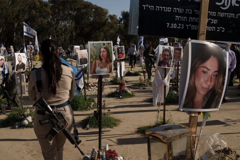 A woman, member of the Israeli forces, visits the site where revelers were killed and kidnapped on Oct. 7 cross-border attack by Hamas militants at the Nova music festival near the kibbutz Reim, southern Israel, Tuesday, March 5, 2024. 