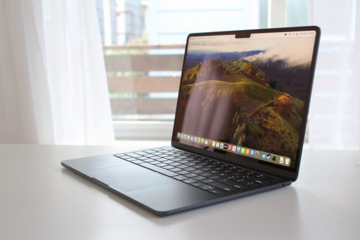 The MacBook Air on a table in front of a window.