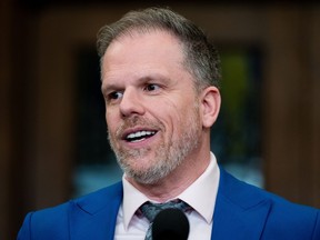 Mark Holland speaks to reporters in the Foyer of the House of Commons on Parliament Hill in Ottawa, on Wednesday, March 20, 2024.