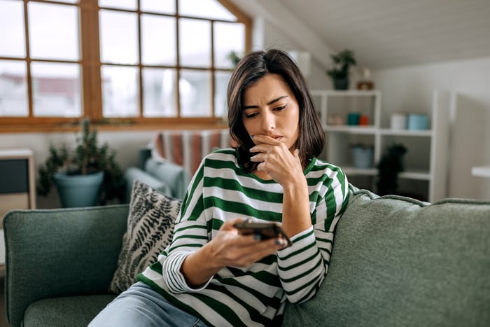 Stressed person looking at smartphone.