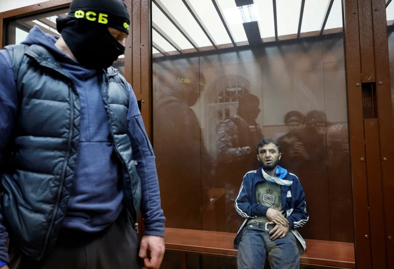 Dalerdzhon Mirzoyev, a suspect in the shooting attack at the Crocus City Hall concert venue, sits behind a glass wall of an enclosure for defendants at the Basmanny district court in Moscow, Russia March 24, 2024. 