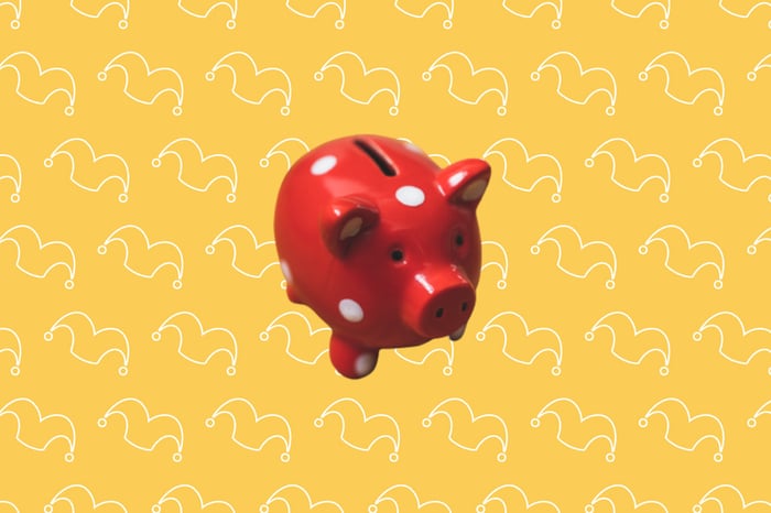 A red piggy bank against a yellow background